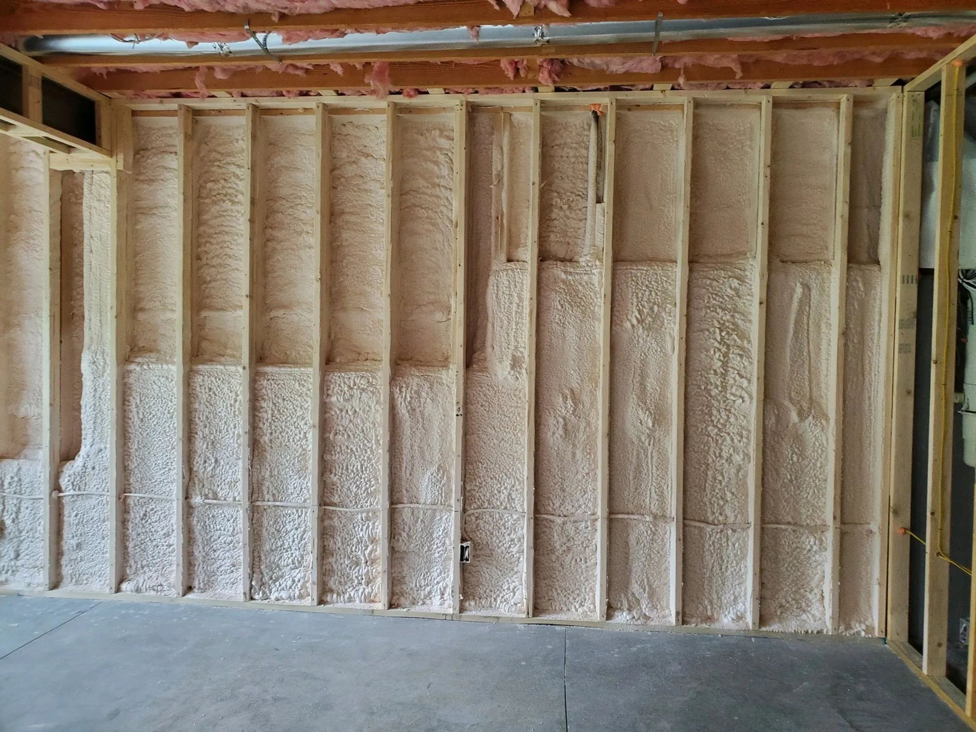 Attic roof deck with spray foam insulation